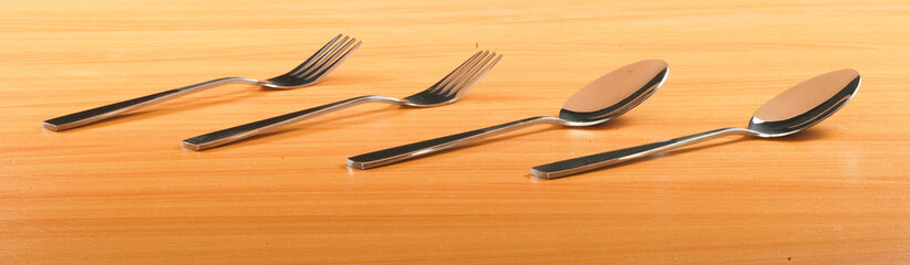 Cutlery. Fork and spoon. On Wooden background.