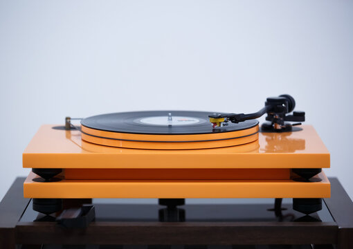 Listen to music in hi fi with analog record player device. High fidelity turn table plays vinyl record with classic music