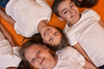 Fototapeta premium Cropped top of smiling children looking at camera