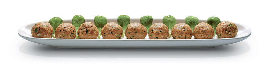 Ready to cook meatballs on white tray.