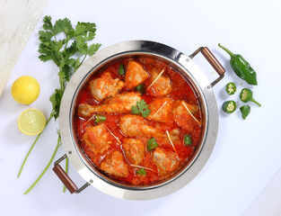 Traditional Pakistani Cuisine, Karahi garnished with lemons and green chilli