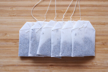 tea bags and yellow color mug on table 