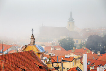 Cityscape on a foggy morning - view of Mala Strana historical neighbourhood of Prague, Czech...