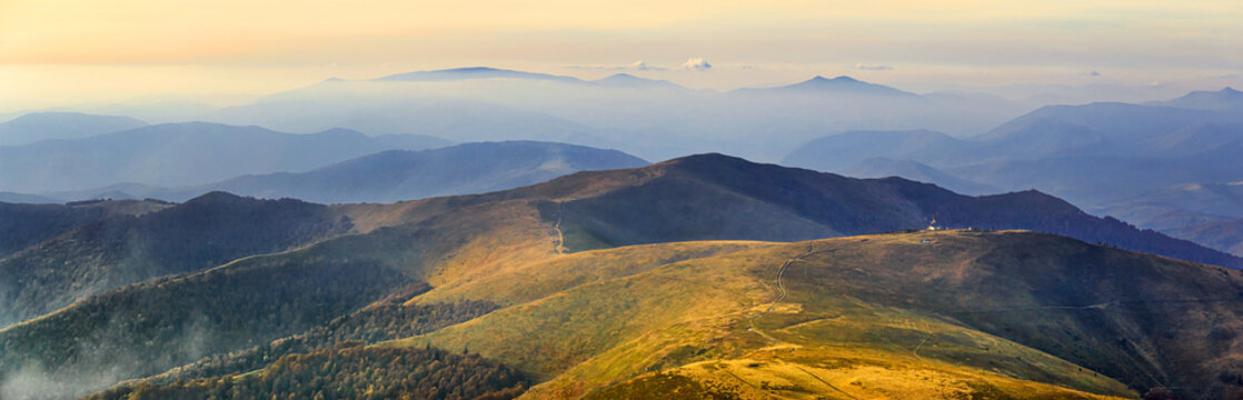 Autumn landscape, panorama, banner - view of the mountains covered with montane meadows and forests under the autumn sun in the Carpathians, Ukraine © rustamank