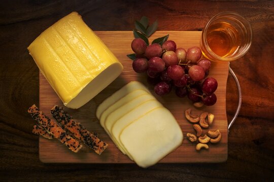 Smoked Mozzarella Cheese Block On Wood Board