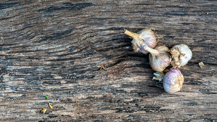 Garlic cloves pile closeup. Garlic clove group on wood rustic table background side view