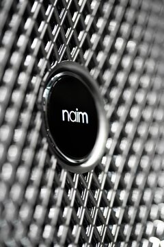 Verticle closeup of the Bentley Naim sound system logo