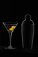 martinin glass with shaker on black background