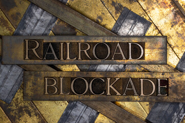 Railroad Blockade text over railroad tracks on vintage textured copper and gold background