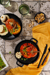 Roasted pumpkin stuffed with chickpeas, quinoa, mushrooms and pepper. Vertical