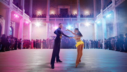 Couple dancers  perform latin dance on large professional stage. Ballroom dancing.