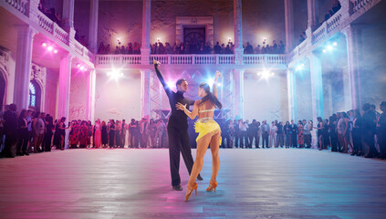 Couple dancers  perform latin dance on large professional stage. Ballroom dancing.