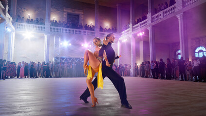 Couple dancers  perform latin dance on large professional stage. Ballroom dancing.