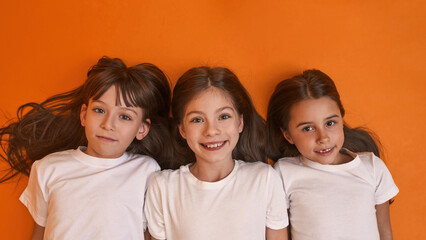 Partial top view of three girls looking at camera