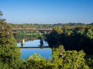 Shepherdstown Pike Bridge with reflection over a calm  Potomac River with clear blue sky in...