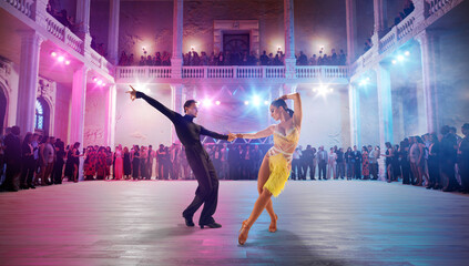 Couple dancers  perform latin dance on large professional stage. Ballroom dancing. - obrazy, fototapety, plakaty