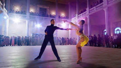 Couple dancers  perform latin dance on large professional stage. Ballroom dancing.