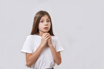 Scared caucasian little girl looking at camera