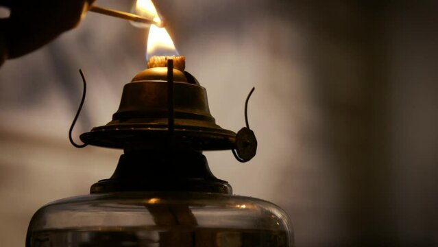 lighting a Victorian oil lamp closeup