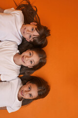 Cropped top view of three girls looking at camera