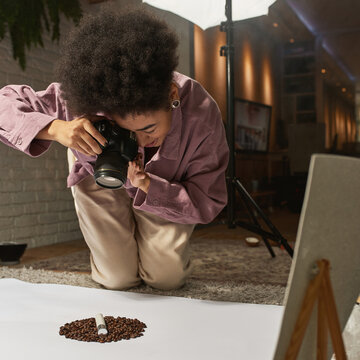 Girl taking photo of coffee beans and cosmetic