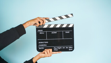 Hand is holding clapper board or clapperboard or movie slate, used in film production and cinema...