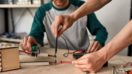 Two partial technicians or engineers do experiment