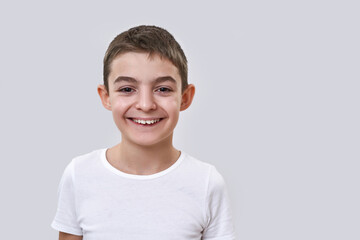 Smiling caucasian little boy looking at camera