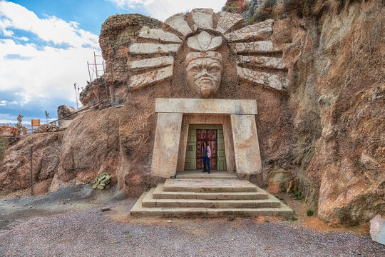 Cusco, Peru - September 24, 2022: La Morada De Los Dioses - Apukunaq Tianan (the abode of the gods), a tourist attraction in Cusco. Here a tourist in the entrance of the temple of the sun god.