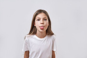 Cropped of caucasian little girl stick out tongue