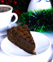 Truffle cake on a white plate on the Christmas table, for the New Year. Close-up