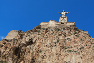 Castle of Monteagudo on the very top of the limestone rock with a statue of Jesus Christ