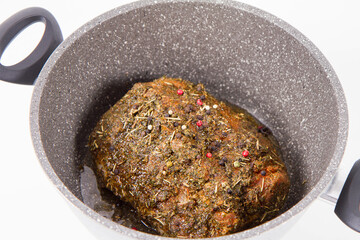 Raw pork loin seasoned - ready to be roasted, in a pot