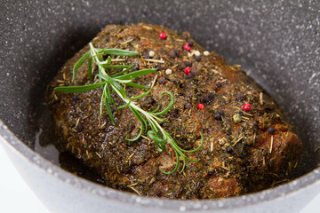Raw pork loin seasoned - ready to be roasted, in a pot