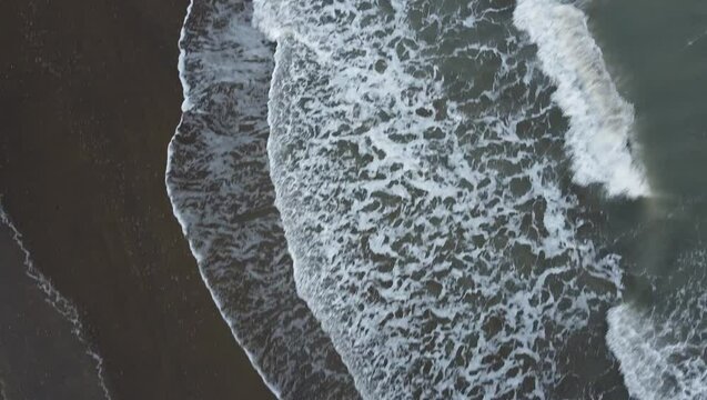 Aerial shot of Eraclea beach with sand, waves and stones, Veneto