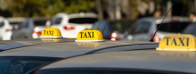 Several cars with a taxi sign