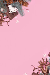 Pine trees branches with Christmas New Year decoration top view, flat lay on pink background with copy space