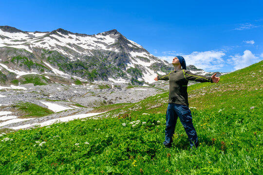 The man hiking in the tropical forest mountians.