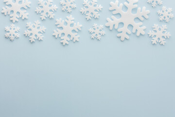 White snowflakes on a blue background, Christmas background, Merry Christmas and Happy New Year concept, top view, copy space