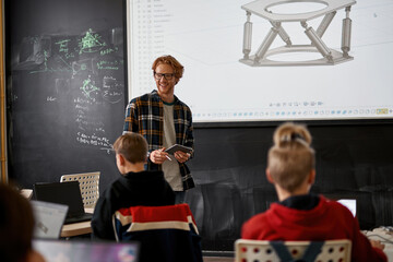 Teacher show robotics model on board for students