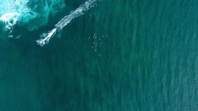 Aerial Top Forward Shot Of People Enjoying Jet Skiing By Tourists With Surfboards In Sea - Waikiki, Hawaii
