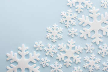 White snowflakes on a blue background, Christmas background, Merry Christmas and Happy New Year concept, top view, copy space