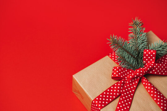 Best Subscription Boxes for Christmas and the Holidays. Xmas Subscription Boxes to Give and Receive. Subscription Gift Box, Care package with red ribbon on red background.