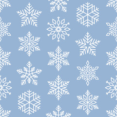 Fototapeta na wymiar White snowflakes on pastel blue background seamless pattern. Best for textile, wallpapers, wrapping paper and seasonal decoration.