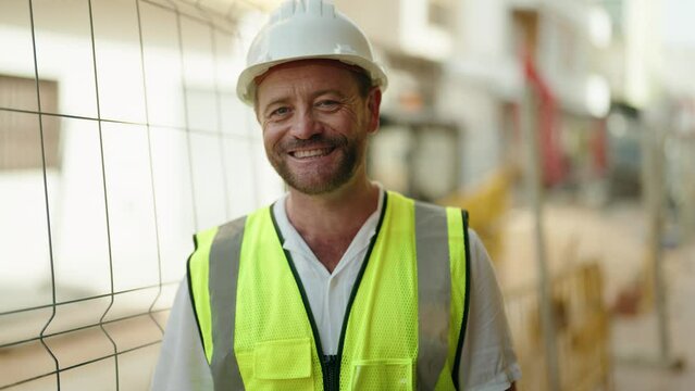 Middle age man architect smiling confident standing at street