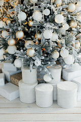 Pile of gift boxes near beautiful Christmas tree indoors