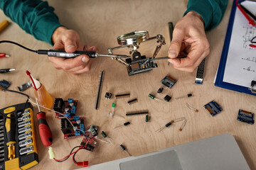 Top view of partial engineer soldering microchip