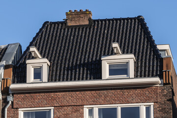 Obraz premium Close-up colorful old buildings with gable rooftops and hooks along Keizersgracht canal in Amsterdam. Keizersgracht (Emperor’s Canal, 1612) named after Emperor of Austria. Amsterdam, the Netherlands.