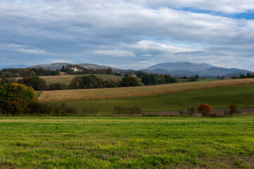 Fototapeta premium Autumn fields with hills and mountains in the background