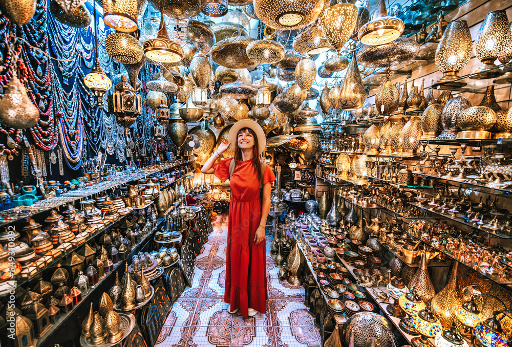 Wall mural Young traveling woman visiting a copper souvenir handicraft shop in Marrakesh, Morocco - Travel lifestyle concept